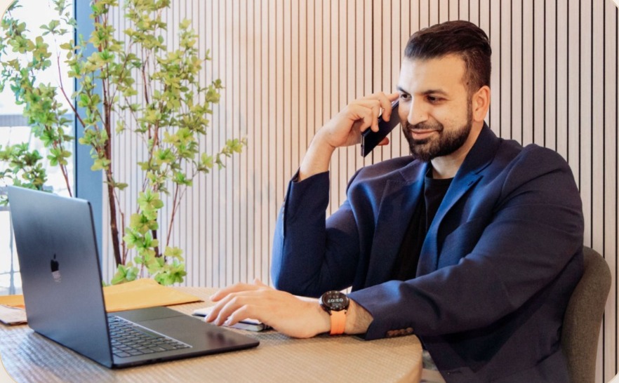 Farooq Ali taking a buyer consultation call at his desk
